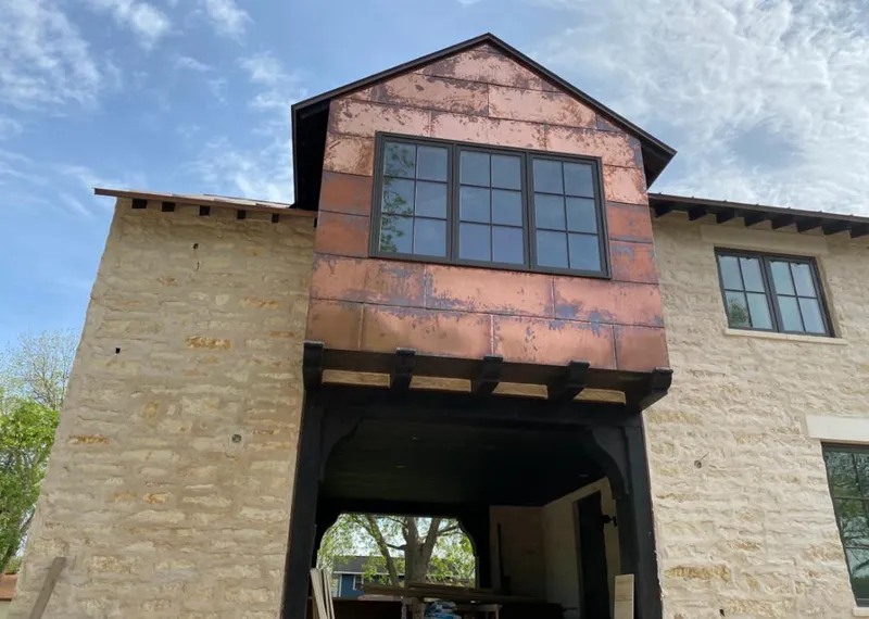 Copper metal panel facade on a stone building for Skylight Installation in Big Flats